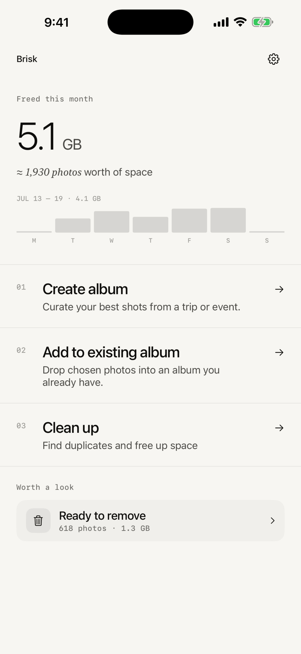 Brisk home screen with 5.1 GB freed this month, a weekly chart, and album and clean-up actions